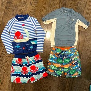 2 Sets of swim trunks and rash guards.